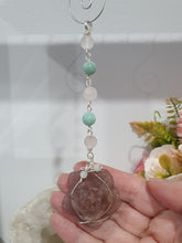 Load image into Gallery viewer, "THE BLUSHING ROSE" Strawberry Quartz Rose Carving silver Crystal Energy Enhancer© Hanger Ornament Suncatcher.

HAPPINESS / LOVE / HARMONY

"THE BLUSHING ROSE - Like the petals of a rose unfolding, The Blushing Rose encourages us to embrace self-love, joy and the beauty within."

Gorgeous Strawberry Quartz Rose Crystal Carving beaded with Ice Pink Malaysian Jade, Rose Quartz, Amazonite and Quartz. Wire wrapped in silver
