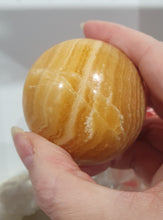 Load image into Gallery viewer, Orange Calcite Sphere Crystal Carving Stone on Silver Stand. This has a crack in it

Inspires JOY AND SELF CONFIDENCE

Lovely Orange Calcite Crystal Sphere on silver stand.  Discounted as has a crack. still a gorgeous sphere.  
