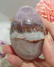 Load image into Gallery viewer, Amethyst Agate Egg Crystal Carving Stone on Stand

Inspires intuition and Emotional Well Being

Beautiful Polished Amethyst Agate Egg Crystal Carving on plastic stand. Has natural divits formations.
