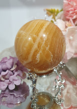 Load image into Gallery viewer, Orange Calcite Sphere Crystal Carving Stone on Silver Stand. This has a crack in it

Inspires JOY AND SELF CONFIDENCE

Lovely Orange Calcite Crystal Sphere on silver stand.  Discounted as has a crack. still a gorgeous sphere.  
