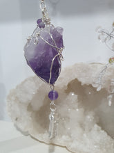 Load image into Gallery viewer, "THE MYSTIC AWAKENING" Handcrafted Amethyst Raw Crystal Stone Silver Crystal Energy Enhancer© Hanger Ornament Suncatcher

INSPIRES INTUITION, WISDOM AND SPIRITUALITY

Stunning Raw Amethyst crystal stone beaded with Amethyst and Quartz. Wire wrapped in silver

Genuine Crystals. no plastic or glass. Ensuring energy flow throughout the enhancer. Hang in your home, work, space and even on your Christmas tree!.  
Genuine Crystal Suncatchers Hangers Christmas Tree Ornaments decorations
