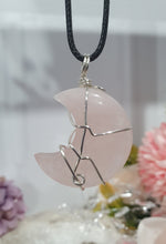 Load image into Gallery viewer, Rose Quartz Moon Crystal Pendant Wire Wrapped Silver Stone with black cord chain

INSPIRES UNCONDITIONAL LOVE &amp; HARMONY

Beautiful Rose Quartz Moon Crystal Carving Wire Wrapper in Silver non tarnish wire. Accompanied by a black cord necklace


