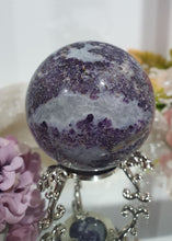 Load image into Gallery viewer, Purple Sphalerite Sphere Crystal Carving on Silver Stand.

Inspires Spirituality &amp; Strength

Stunning Purple Sphalerite Crystal Sphere on Silver Sand. This has a gorgeous quartz vein and pocket of druzy. 
