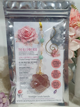 Load image into Gallery viewer, "THE BLUSHING ROSE" Strawberry Quartz Rose Carving gold Crystal Energy Enhancer© Hanger Ornament Suncatcher.

HAPPINESS / LOVE / HARMONY

"THE BLUSHING ROSE - Like the petals of a rose unfolding, The Blushing Rose encourages us to embrace self-love, joy and the beauty within."

Gorgeous Strawberry Quartz Rose Crystal Carving beaded with Ice Pink Malaysian Jade, Rose Quartz, Amazonite and Quartz. Wire wrapped in gold
