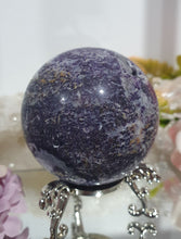 Load image into Gallery viewer, Purple Sphalerite Sphere Crystal Carving on Silver Stand.

Inspires Spirituality &amp; Strength

Stunning Purple Sphalerite Crystal Sphere on Silver Sand. This has a gorgeous quartz vein and pocket of druzy. 
