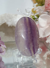 Load image into Gallery viewer, Fluorite Crystal Palm Stone palmstone on plastic stand. 

Inspires CONCENTRATION AND STABILITY

Lovely Fluorite Crystal Palm stone on plastic stand. So pretty.  

