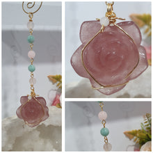 Load image into Gallery viewer, "THE BLUSHING ROSE" Strawberry Quartz Rose Carving gold Crystal Energy Enhancer© Hanger Ornament Suncatcher.

HAPPINESS / LOVE / HARMONY

"THE BLUSHING ROSE - Like the petals of a rose unfolding, The Blushing Rose encourages us to embrace self-love, joy and the beauty within."

Gorgeous Strawberry Quartz Rose Crystal Carving beaded with Ice Pink Malaysian Jade, Rose Quartz, Amazonite and Quartz. Wire wrapped in gold
