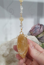 Load image into Gallery viewer, This stunning Ultimate Healer Crystal Energy Enhancer Suncatcher is handcrafted and created with a stunning Golden Healer heart and beaded with golden healer and quartz. Hang in your home or space and feel the ambient energy. Inspires Power and connection. See our other Crystal Suncatchers
