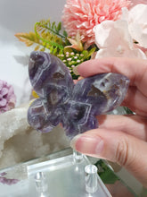 Load image into Gallery viewer, Butterfly Amethyst Crystal Carving Stone on Stand. Inspires Intuition and Spirituality.

Beautiful polished Amethyst Chevron Butterfly Crystal Carving on plastic stand
