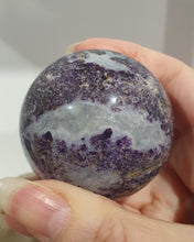 Load image into Gallery viewer, Purple Sphalerite Sphere Crystal Carving on Silver Stand.

Inspires Spirituality &amp; Strength

Stunning Purple Sphalerite Crystal Sphere on Silver Sand. This has a gorgeous quartz vein and pocket of druzy. 
