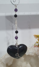 Load image into Gallery viewer, THE WITCHES HEART" Handcrafted Obsidian Heart Crystal Carving Stone Silver Crystal Energy Enhancer© Hanger Ornament Suncatcher 

INSPIRES MAGIC, INTUITION AND PROTECTION

Gorgeous Obsidian heart crystal carving stone beaded with Black Obsidian, Amethyst and Herkimer Diamonds. Wire wrapped in silver
