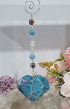 Load image into Gallery viewer, HEART OF THE OCEAN" Handcrafted Titanium Aura Sphalerite Heart Crystal Carving Silver Crystal Energy Enhancer© / Hanger / Ornament / Suncatcher

Inspires PSYCHIC FLOW | LOVE | INTUITION

Gorgeous Titanium Aura Sphalerite heart crystal carving stone beaded with Aquamarine, Rainbow Hematite &amp; Quartz.  Wire wrapped in silver
