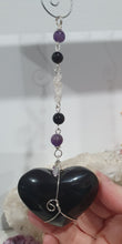 Load image into Gallery viewer, THE WITCHES HEART" Handcrafted Obsidian Heart Crystal Carving Stone Silver Crystal Energy Enhancer© Hanger Ornament Suncatcher 

INSPIRES MAGIC, INTUITION AND PROTECTION

Gorgeous Obsidian heart crystal carving stone beaded with Black Obsidian, Amethyst and Herkimer Diamonds. Wire wrapped in silver
