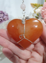 Load image into Gallery viewer, HEART OF LOVE &amp; SEDUCTION" -  - Carnelian Heart Silver Wired Stone Crystal Energy Enhancer© Hanger Suncatcher Ornament 200mm | Inspires Sensuality, Love &amp; Stability

INSPIRES SENSUALITY | LOVE | STABILITY 

Carnelian heart Crystal Energy Enhancer© / Hanger / Ornament beaded with Carnelian, Rose Quartz, Hematite, Herkimer Diamonds and quartz.  wired in silver
