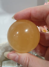 Load image into Gallery viewer, Honey Calcite Sphere Crystal Carving on silver stand

INSPIRES SELF WORTH AND CONFIDENCE

lovely Honey Calcite sphere on ornate silver stand
