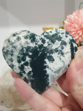 Load image into Gallery viewer, Heart Moss Agate Crystal Carving Stone on stand

INSPIRES GROUNDING AND CONNECTION TO EARTH

Lovely Moss Agate Heart Crystal Carving on silver stand. 
