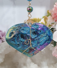 Load image into Gallery viewer, HEART OF THE OCEAN" Handcrafted Titanium Aura Sphalerite Heart Stone Crystal Carving Gold Crystal Energy Enhancer© / Hanger / Ornament / Suncatcher

Inspires PSYCHIC FLOW | LOVE | INTUITION

Gorgeous Titanium Aura Sphalerite heart crystal carving beaded with Aquamarine, Rainbow Hematite &amp; Quartz.  Wire wrapped in gold
