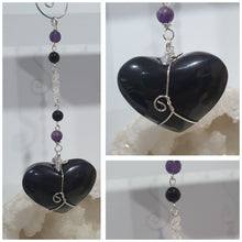 Load image into Gallery viewer, THE WITCHES HEART" Handcrafted Obsidian Heart Crystal Carving Stone Silver Crystal Energy Enhancer© Hanger Ornament Suncatcher 

INSPIRES MAGIC, INTUITION AND PROTECTION

Gorgeous Obsidian heart crystal carving stone beaded with Black Obsidian, Amethyst and Herkimer Diamonds. Wire wrapped in silver
