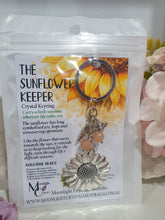 Load image into Gallery viewer, THE SUNFLOWER KEEPER" Metal Sunflower with Sunstone Beads Crystal Keyring.

Choose from Gold of Silver medal colour.

INSPIRES JOY | HOPE | OPTIMISM

Carry a little Sunshine wherever life takes you!

 "The sunflower has long symbolised joy, hope and unwavering optimism. Like the flower that turns towards the sun, it reminds us to keep looking for the light, even through life's difficult seasons".

Gorgeous Metal sunflower Keyring Key ring beaded with AAA sunstone faceted beads.


