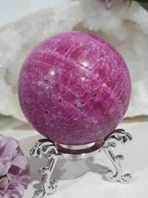Load image into Gallery viewer, Ruby Sphere Crystal Carving on Silver Stand.  Inspires Attraction and Sensuality. Sphere is a little darker than pics show

